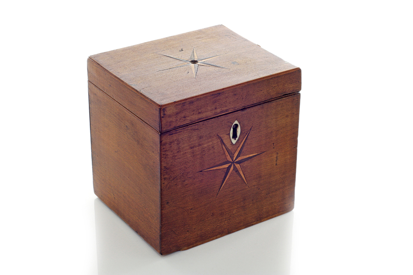 A George III mahogany tea caddy, the top and front inlaid with boxwood and ebony stars, with ivory