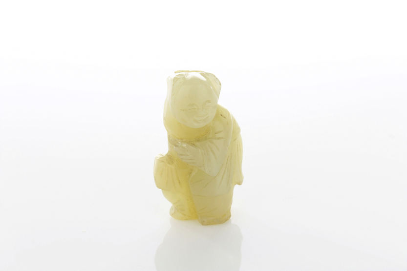 A Chinese carved jade pendant of a scholar, late 19th century, 5cm high