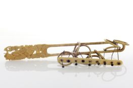 A Japanese Export carved ivory puzzle, circa 1900, the handle carved with all around with a mother