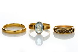 A 22ct gold wedding band converted to a single stone ring set with blue oval topaz, together with