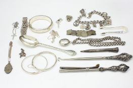 A small collection of silver items, comprising a charm bracelet, three bangles, locket necklace,