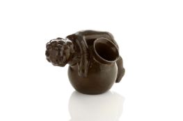 Just Andersen Danish (1884-1943), A bronzed ‘disko’ metal inkwell formed as a cherub resting on a