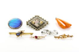 Six assorted brooches and a pendant, comprising: two gold bar brooches, two silver brooches and