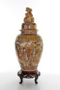 A large Japanese Satsuma vase and cover, circa 1900, the lid crested with a gilt dog of foe, the