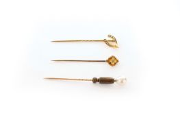 Two Victorian 15ct gold stick pins and another, One with seed pearl mounted wishbone top, one with