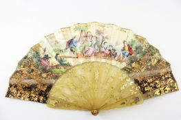 A 19th century French paper fan with gilt and hand painted decoration of pastoral scenes, with