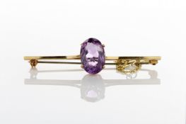 A 9ct gold bar brooch set with large oval faceted amethyst, with safety chain, in fitted case,