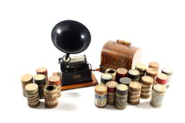 An Edison Gem Cylinder Phonograph, set on an oak base with domed top case and carrying handle,