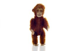 A German Schuco miniature monkey scent bottle circa 1930, cinnamon mohair with felt hands and feet