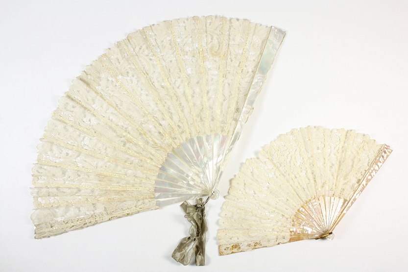 Two cream lace and mother-of-pearl fans, 20th century, the larger in a case, the largest 36cm