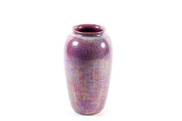 A Ruskin lustre ware vase, of mottled iridescent purple with impressed Ruskin mark to underside,