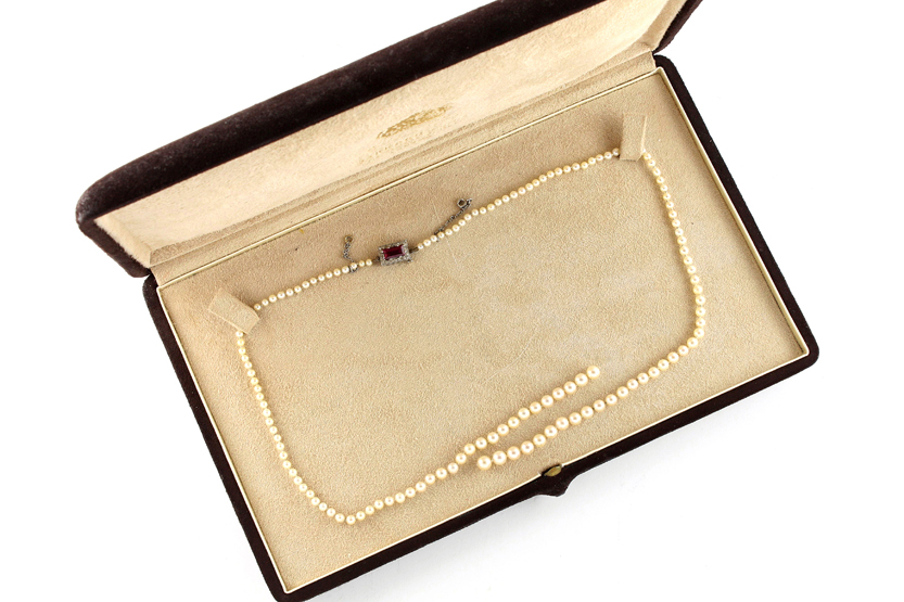 A single row of graduated pearls with ruby and diamond clasp of rectangular form, sold by Garrard