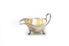 A Mappin & Webb silver plated sauce boat, with ribbon lined rim and handle and supported on curved