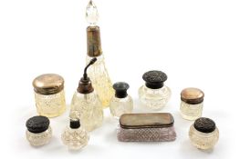 A collection of ten assorted silver topped glass dressing table items, including bottles, boxes