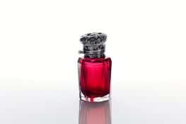 An Edwardian silver topped cranberry glass scent bottle, hallmarked Birmingham 1908, the hinged