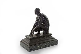 A Victorian bronze figure of a nude man, kneeling and holding a trowel, a robe over his shoulder,