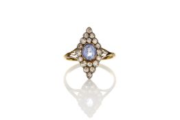 A gold marquise shaped dress ring, set with centre pale blue sapphire surrounded by eighteen small