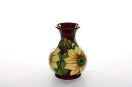 A modern Moorcroft ‘Sunflower’ pattern vase, of bulbous baluster form with tubelined decoration on a