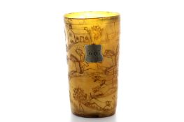 An early 19th century engraved horn hunting beaker, engraved throughout with hunting scenes of