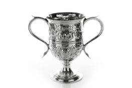 A George III silver two handled cup, hallmarked London 1815, with twin scrolled handles and embossed