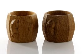 A pair of Robert Thompson ‘Mouseman’ carved oak napkin rings, of octagonal barrel form, each with