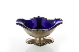 An Edwardian oval silver boat shaped pedestal bowl, hallmarked London 1906, with scrolled rim and