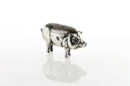 A silver pin cushion in the form of a pig, circa 1908, with stamped inscription to one side