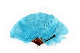 A small blue ostrich feather fan, early 20th century, with faux tortoiseshell sticks, length 27cm