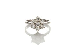 An 18ct white gold diamond cluster ring set with seven small diamonds in claw setting, size ‘M’