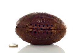 A miniature leather Rugby ball, mid 20th century, with stamped letters ‘MATCH’, with yellow