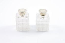 A pair of Victorian silver topped scent bottles, hallmarked London 1861 with engraved decoration,