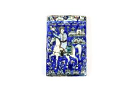 A 19th century Persian pottery pictorial tile, depicting a hunter on horseback with a bird of