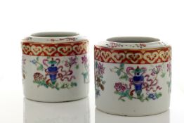 A pair of Chinese porcelain brush pots, circa 1900, painted with enamel panels of flowers and vases,