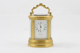 A miniature oval carriage timepiece French, circa 1890, with retailers name M.SAURY CIE on enamel