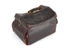 A burgundy leather covered gladstone bag by Hill and Millard English, circa 1900, opening up to