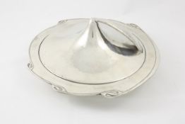 A pewter muffin dish designed by Archibald Knox circa 1905, the rim cast with Celtic scrolls,