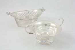 A silver pedestal bon-bon dish Sheffield 1906/07, with high scroll handles, hand beaten body, of low