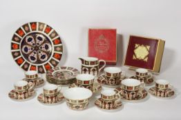 A collection of Royal Crown Derby `Old Imari` pattern 1128 comprising a dinner plate, five coffee