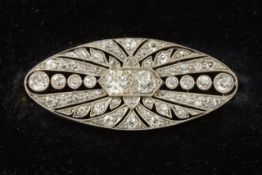 An Art Deco diamond plaque brooch 1930s, of oval form set with numerous small diamonds and two old