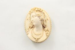 An ivory brooch late 19th century, of oval form with bust of lady carved in high relief with long