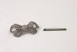 An Edwardian silver coloured metal bow brooch set with numerous white paste stones and a silver