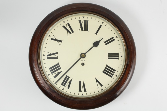 An English dial timepiece circa 1910, with 12-inch painted dial stamped G.P.O, 8-day fusee movement,