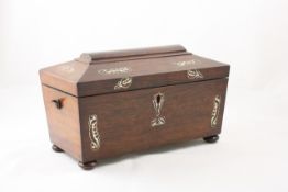 A rosewood tea caddy of sarcophagus form English, mid 19th century, inlaid with mother of pearl