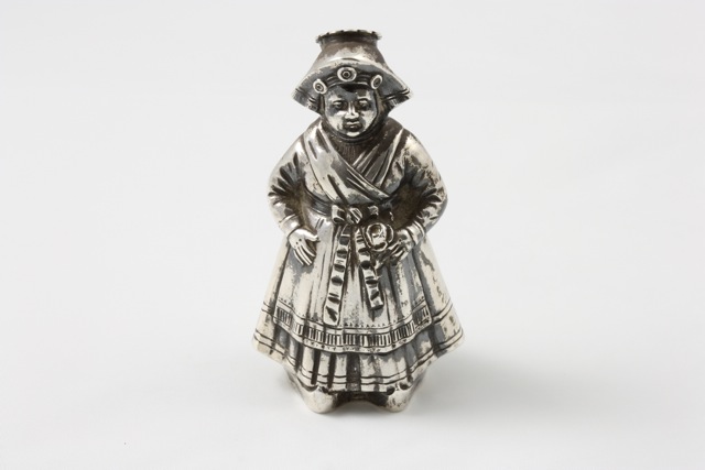 A Continental silver pepper caster circa 1909, in the form of a Dutch woman in national costume,