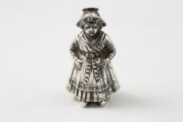 A Continental silver pepper caster circa 1909, in the form of a Dutch woman in national costume,