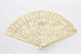 A late 19th century Chinese carved ivory fan overall carved with Chinese figures in domestic scenes,