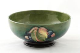 A Moorcroft `Leaf and fruit` small bowl 1930s, with tube lined decoration on green ground, with blue
