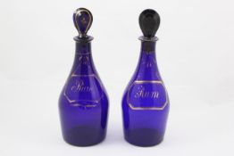 A pair of late 19th century Bristol blue rum decanters with stoppers with gilt decoration, height