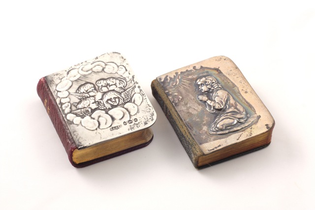 Two miniature Common Prayer books with silver front covers Edwardian, the first silver embossed