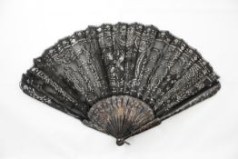 A 19th century tortoiseshell and embroidered fan with tortoiseshell sticks decorated with pique